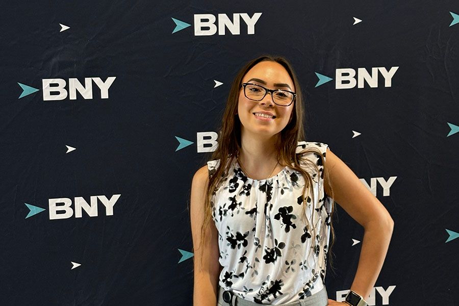 Saarah Valentin poses before a BNY-branded event backdrop.