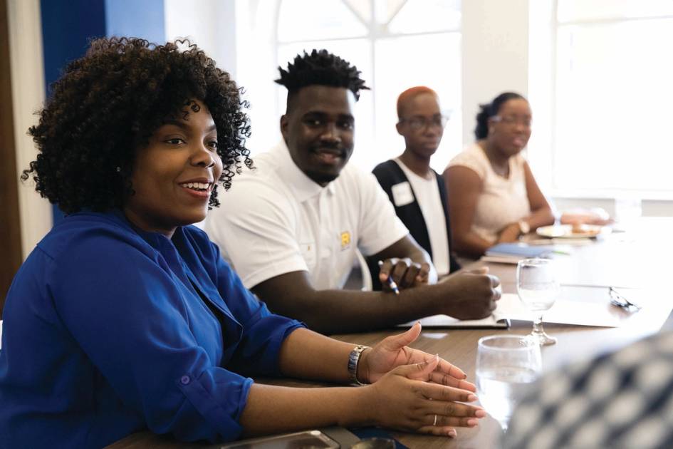 A Rollins alum meets with a group of Rollins students.