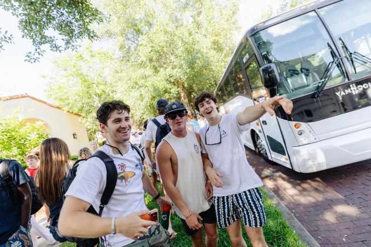 Students posing in front of the bus to the beach