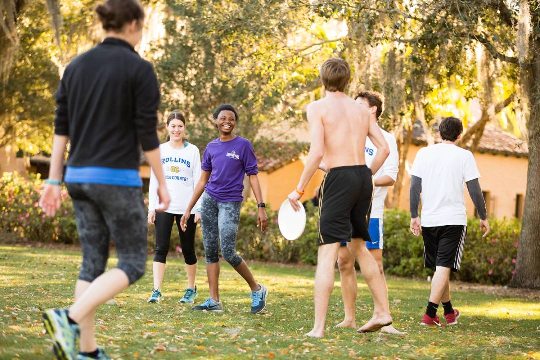 Students play ultimate frisbee on Mills Lawn at Rollins.