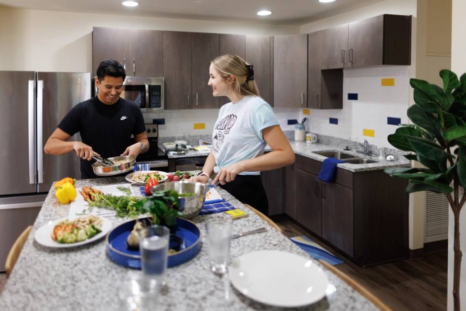 Students talking and cooking in their Lakeside kitchen