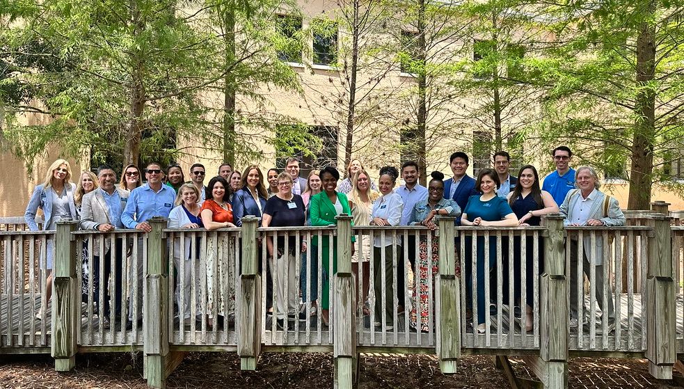 Group photo of alumni advisory board members on campus.