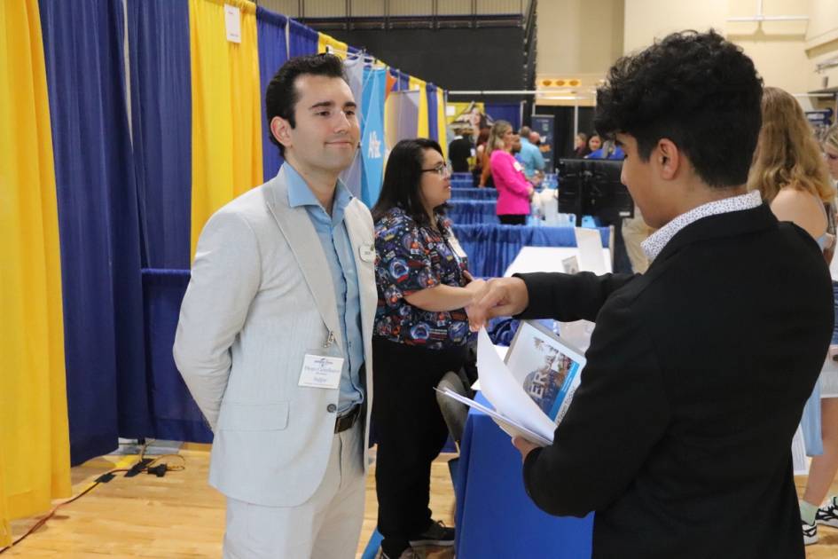 student talking to employer at job fair