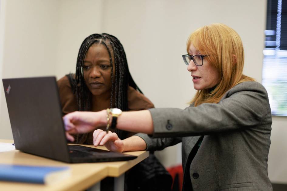 A professor works one on one with a communication studies student at Rollins.