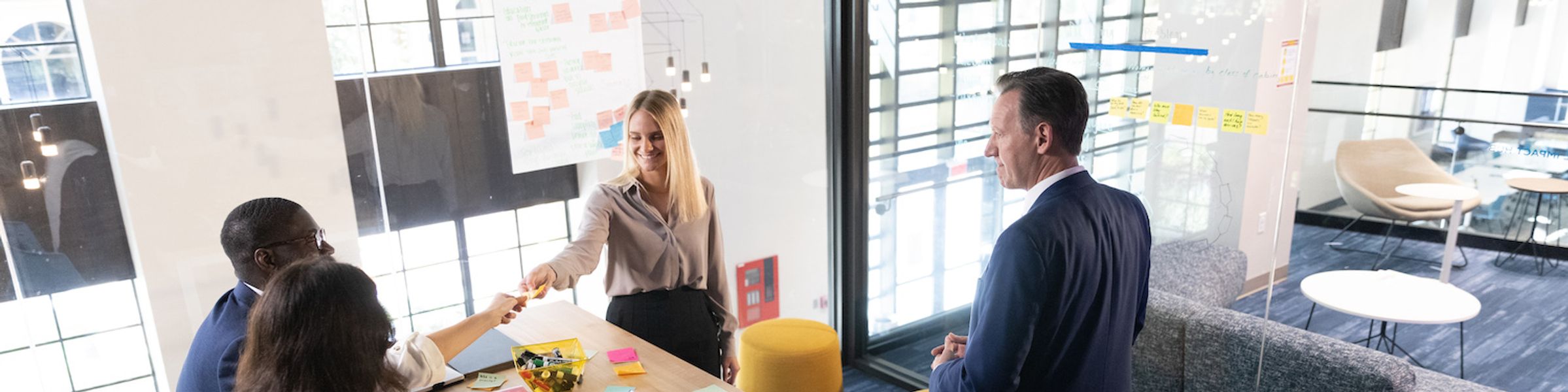 People meet in a conference room to brainstorm.