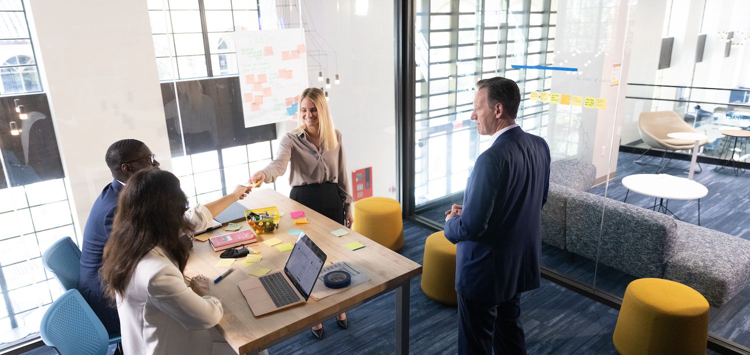 Rollins students work with a mentor in the social impact hub on campus