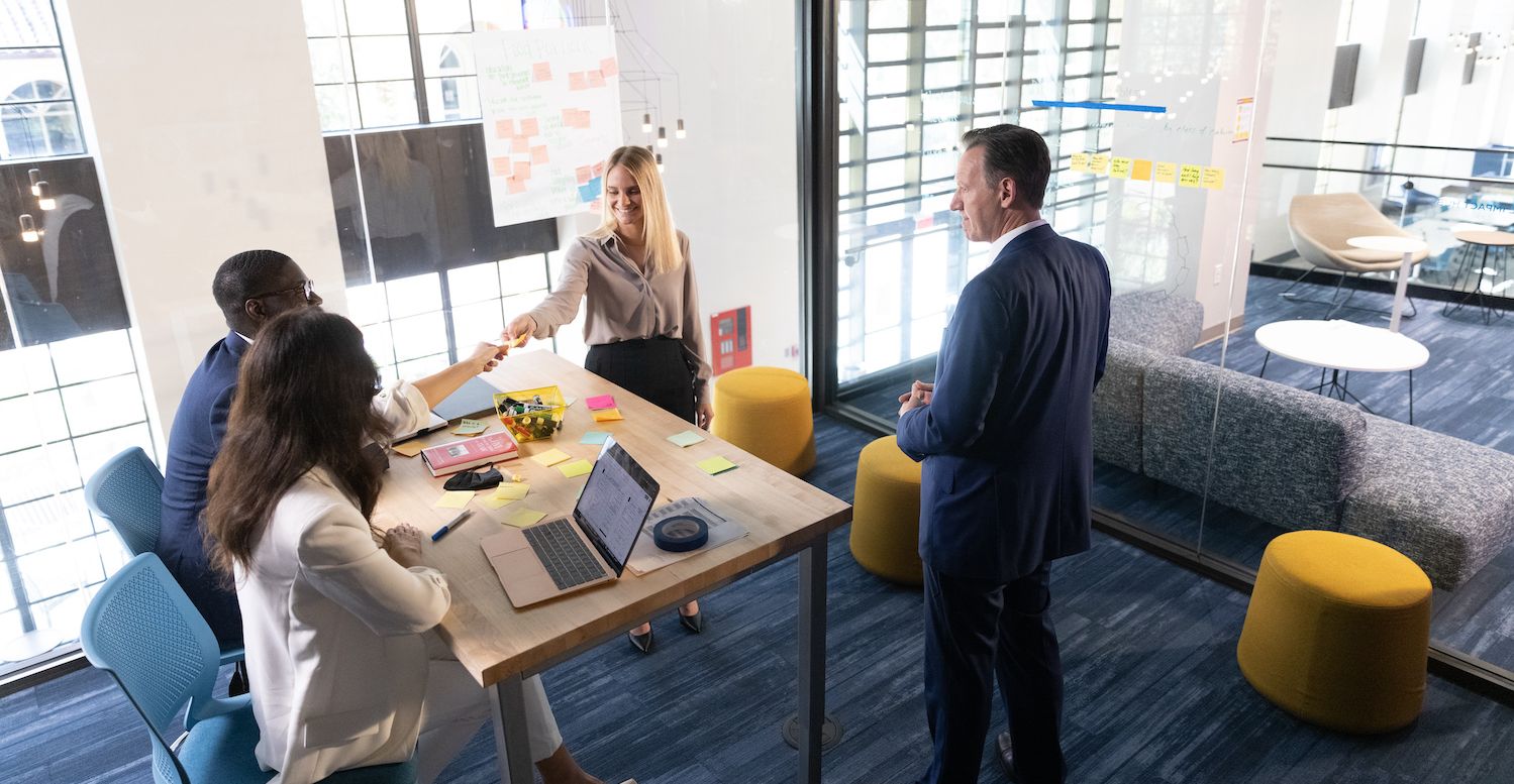 People meet in a conference room to brainstorm.