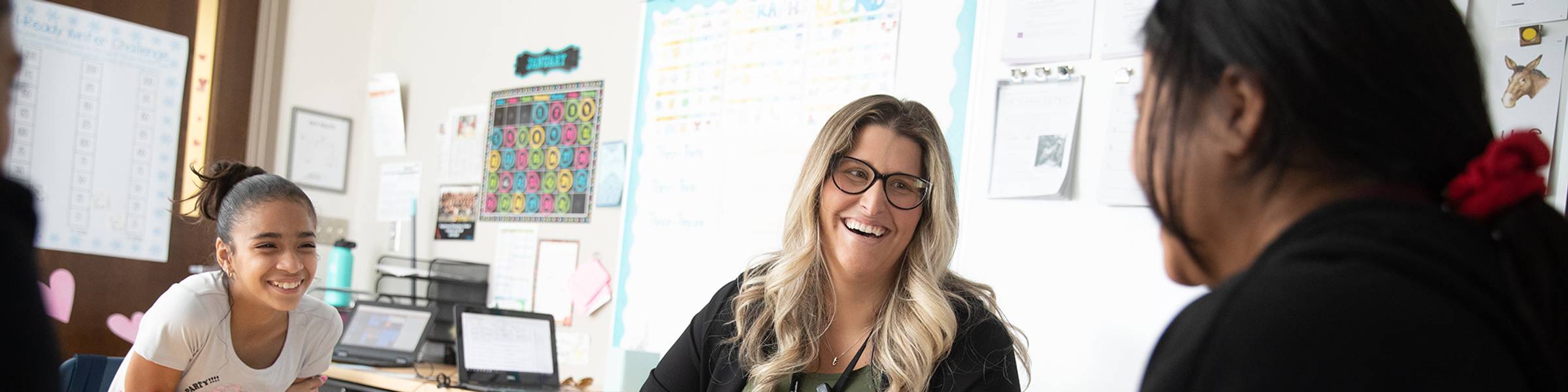 A teacher works with middle-school students.