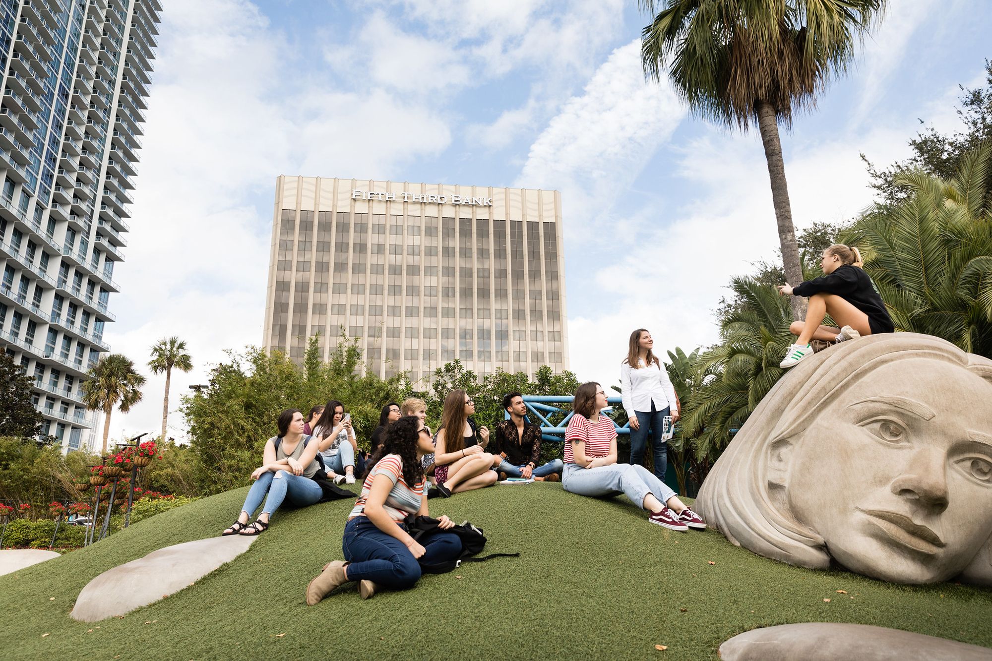 A group of students explores a public art installation in downtown Orlando.