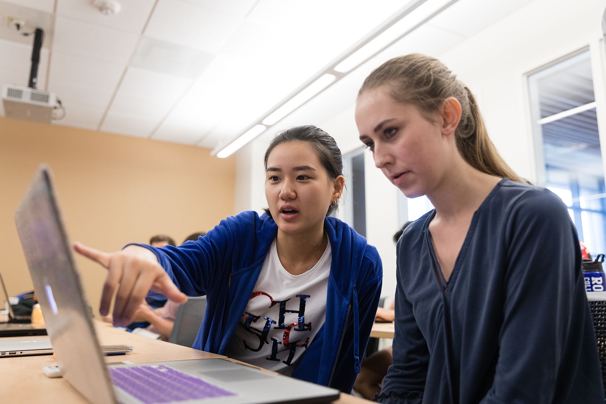 Computer science students collaborate on analyzing data.