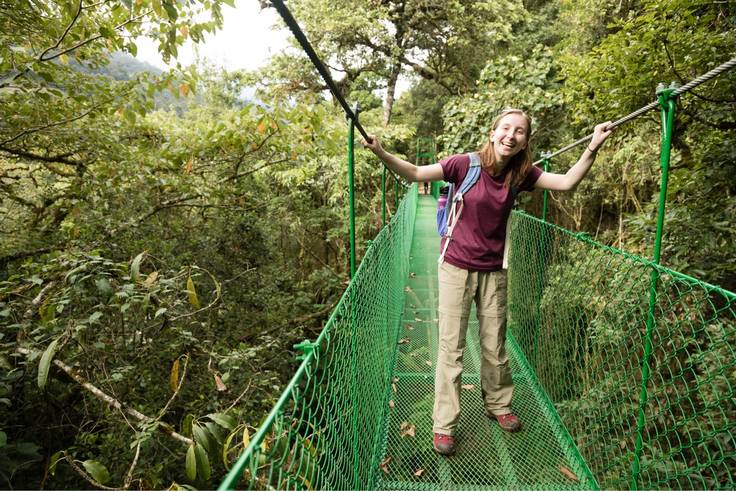 A student poses for a photo on a rope bridge in a Costa Rican cloud forest.