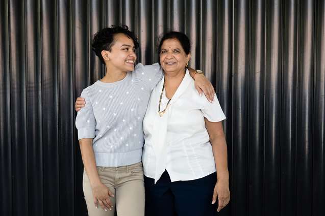 A scholarship advisor standing with one of the top scholarship recipients.