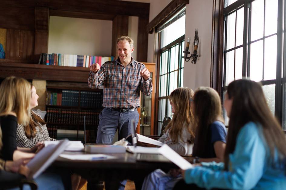 A professor leads a small discussion-based class.