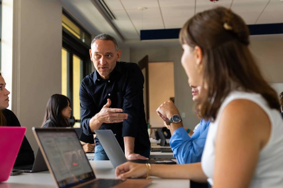 A professor explains a concept to a small group of college students.