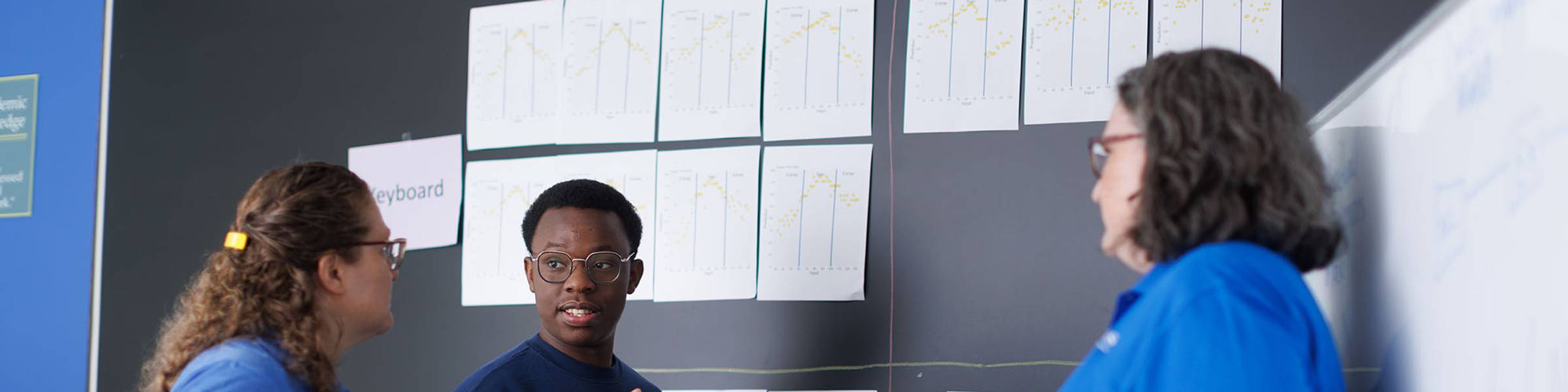 Rollins professors and a student work together on a research project.