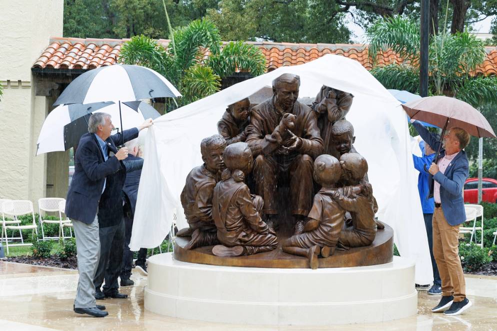 President Grant Cornwell and artist Paul Day unveil the sculpture honoring Mister Rogers.