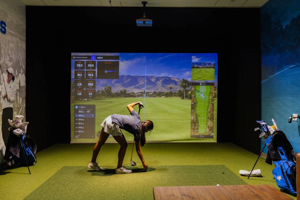Student-athlete using the new golf simulator