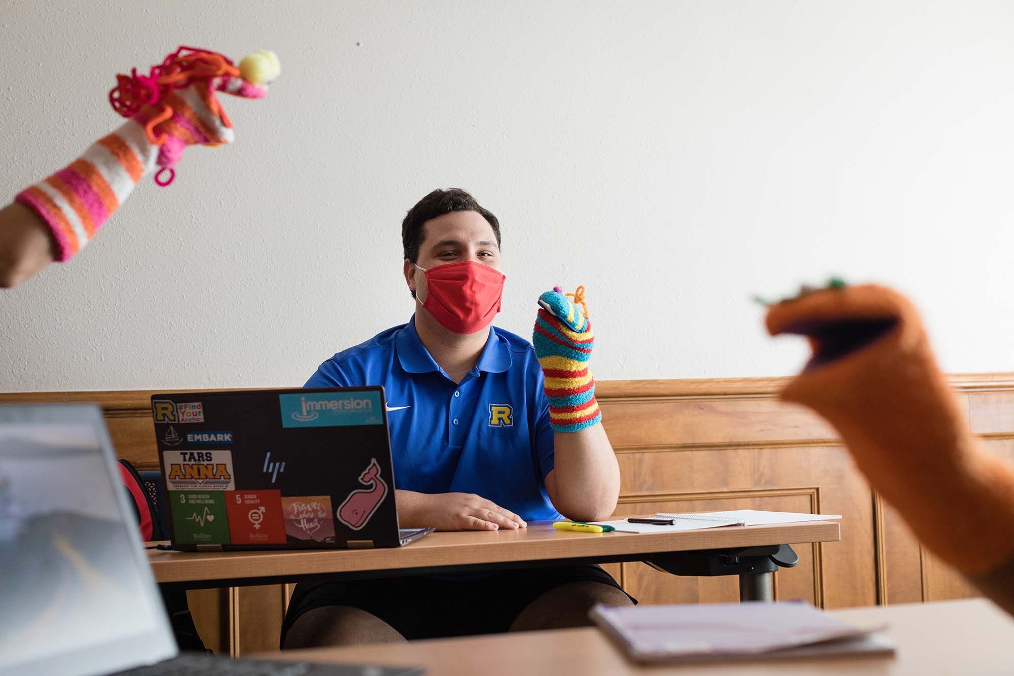 A student participates in a puppet workshop