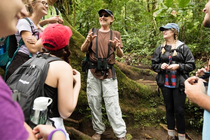 Environmental studies professor and his students discussing sustainability and conservation in a Costa Rican rainforest.