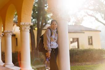 A college student poses on the Rollins College campus.