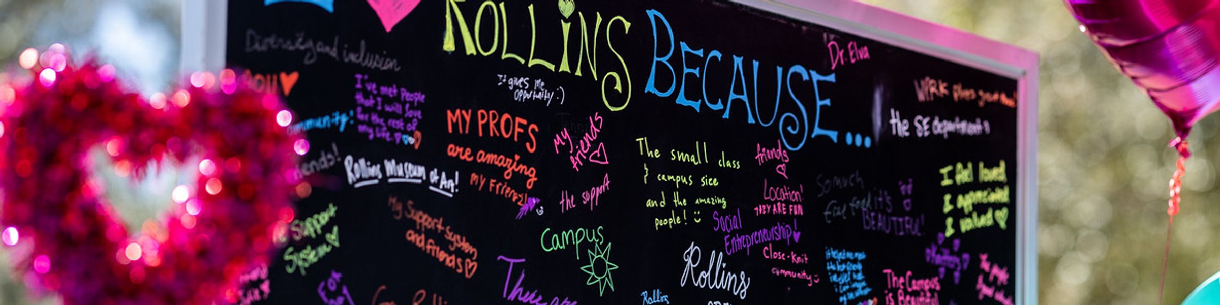 Students writing on a chalkboard outside with the title I Love Rollins Because