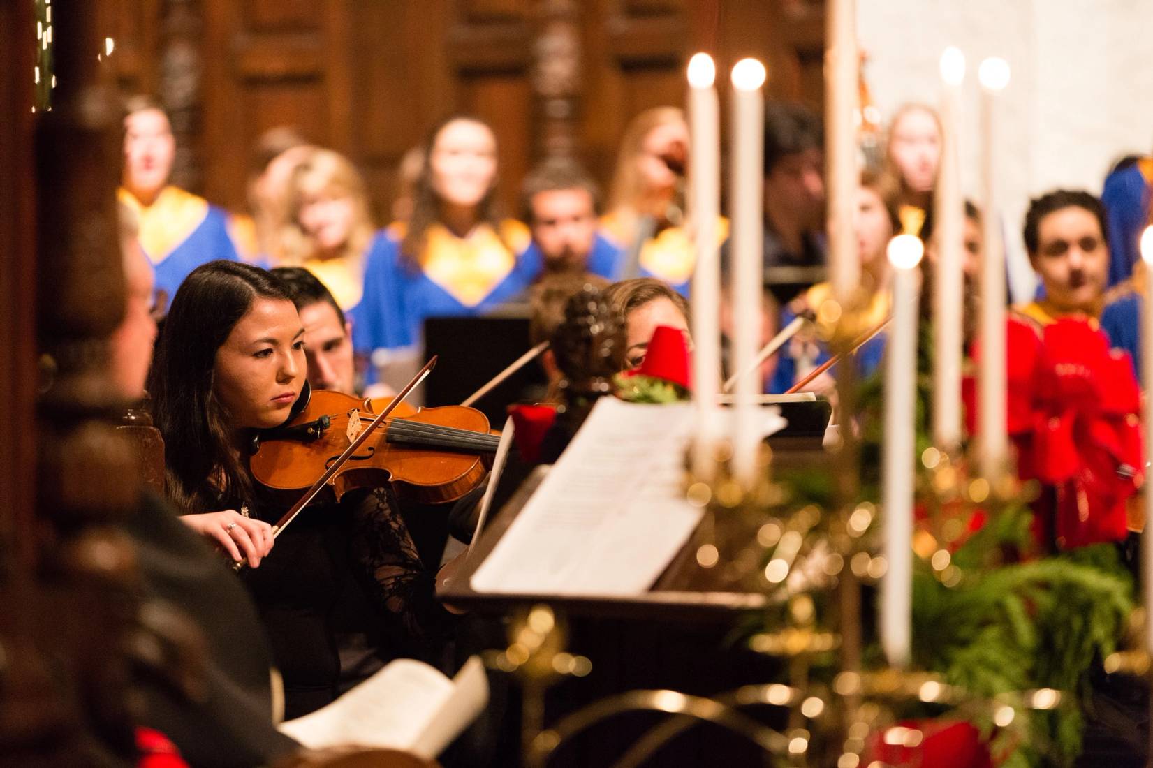 Violinist playing in Christmas Vespers holiday concert in Knowles Memorial Chapel