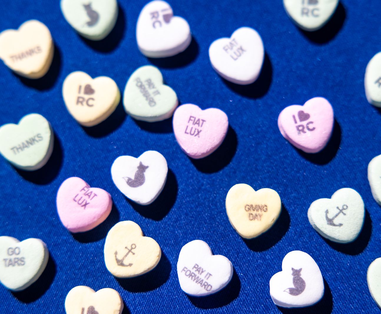 Pastel multi-colored hearts with Fiat Lux, Giving Day, and Rollins Logos on them