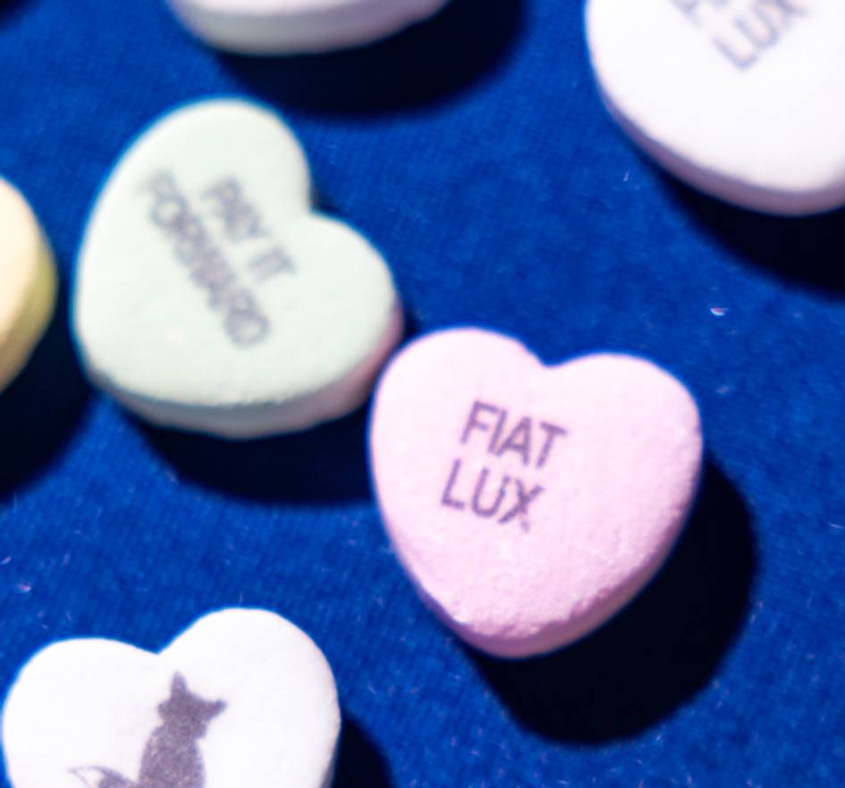 Green candy heart with a fox silhouette on it.