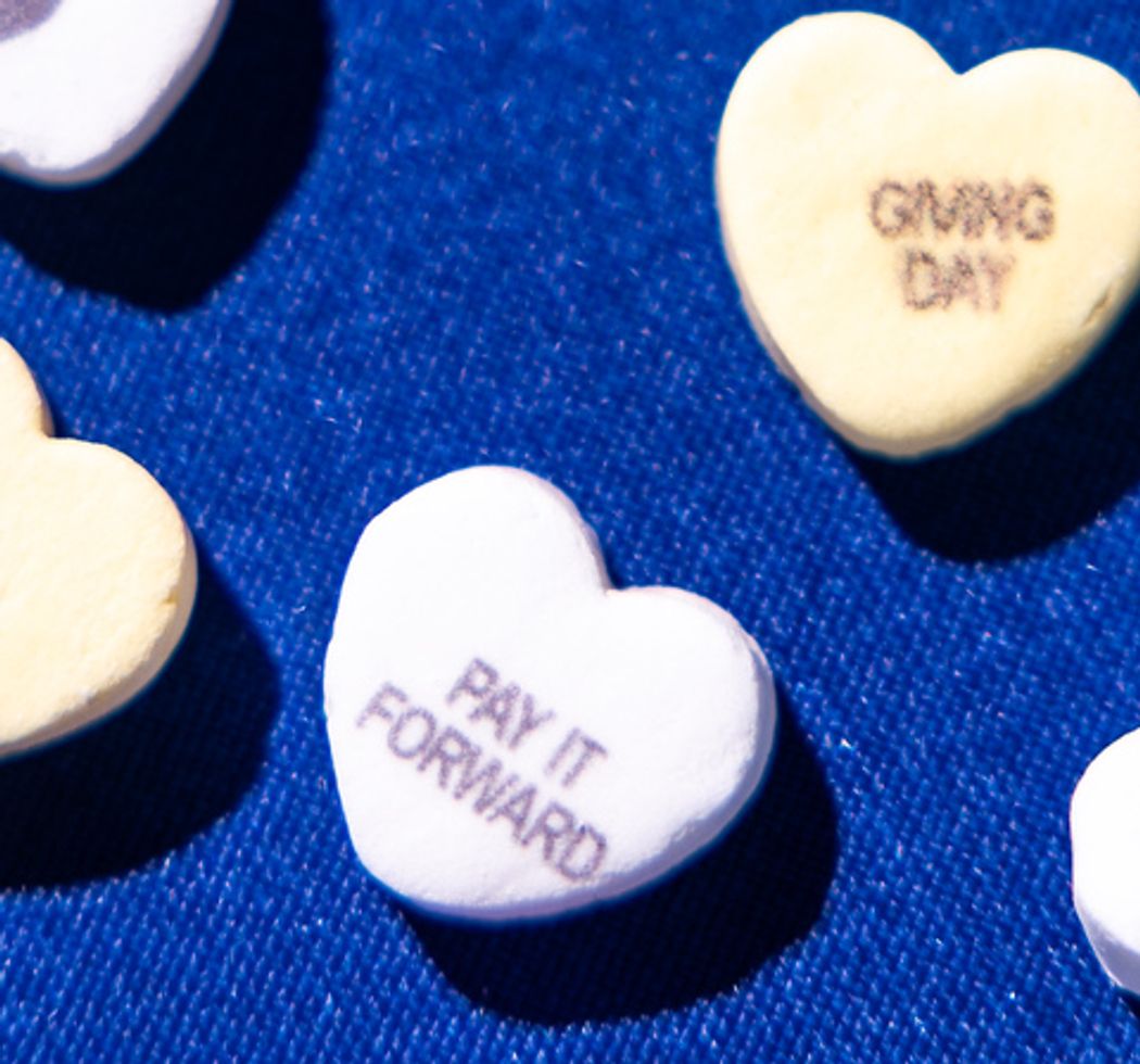 Green candy heart with an anchor silhouette on it. 