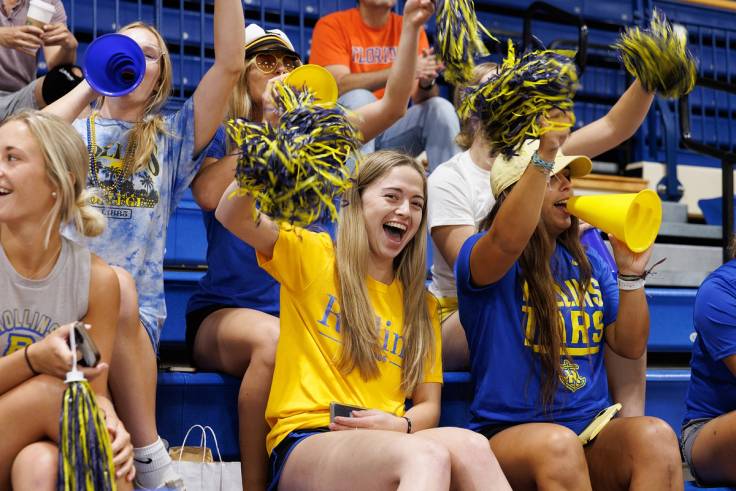 Students wearing blue and gold and cheering on College Colors Day.