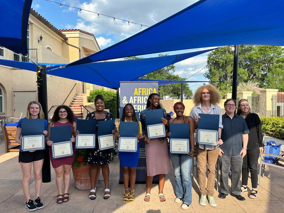 A group of Rollins students post at a event for the African and African American Studies (AAAS) program.