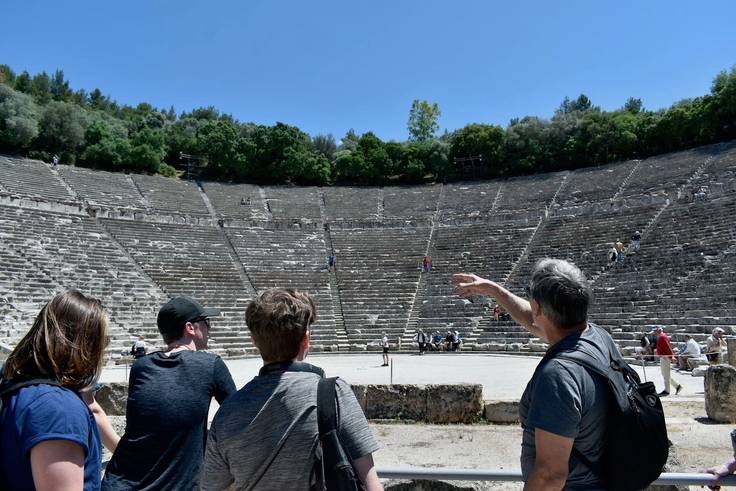 Rollins professor shows a Greek theatre to students on a field study to Greece