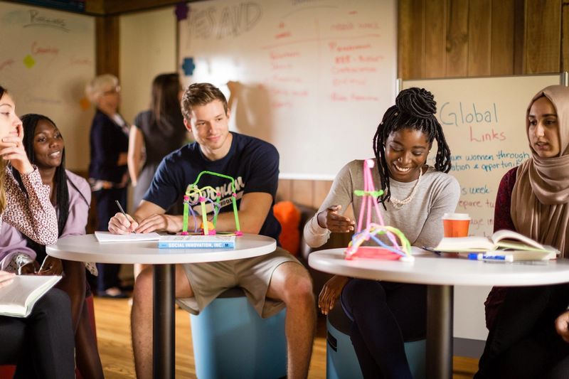 A group of students brainstorm in Rollins’ social impact hub.