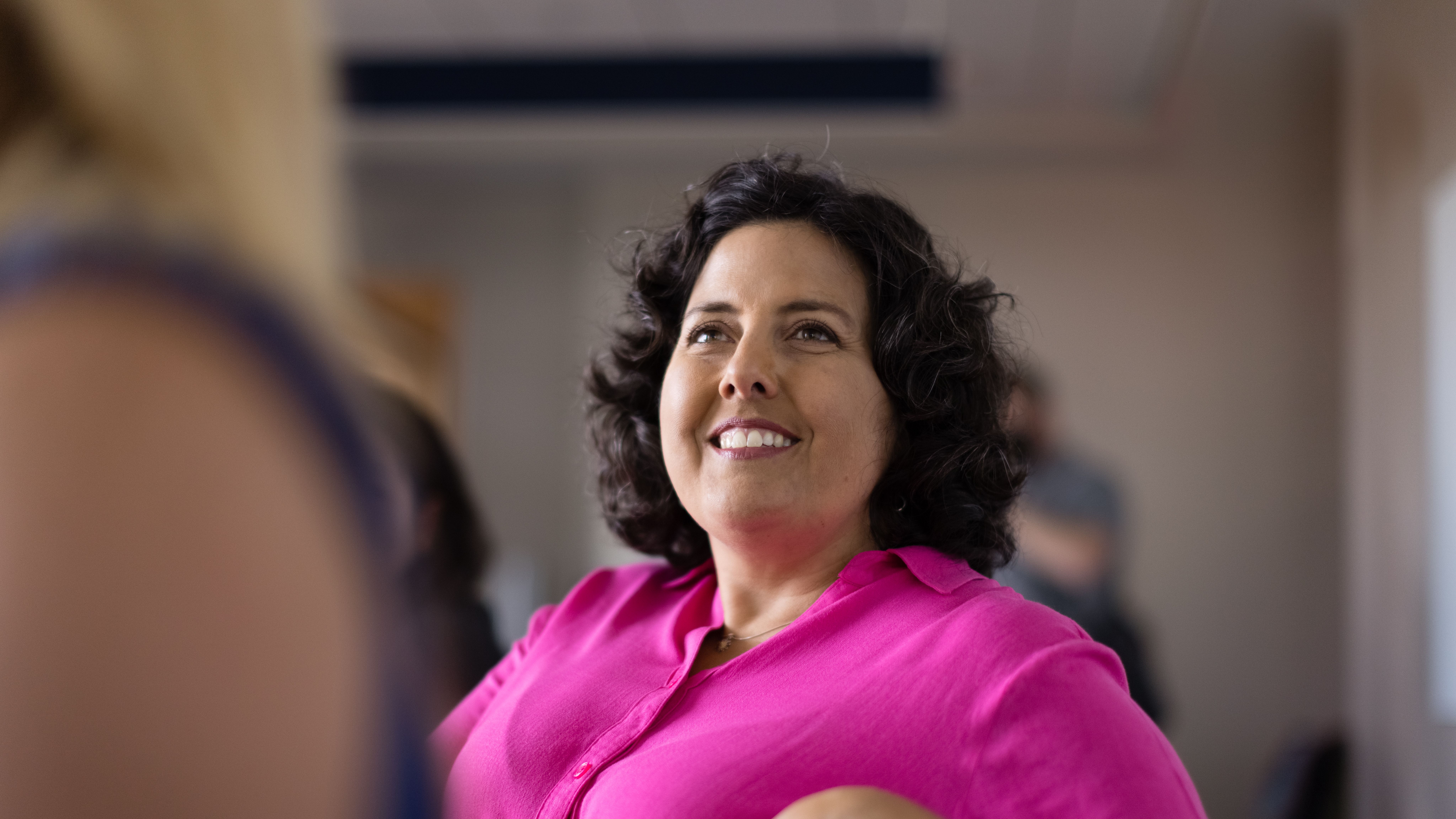 A prospective student listens to an admission counselor during an information session.