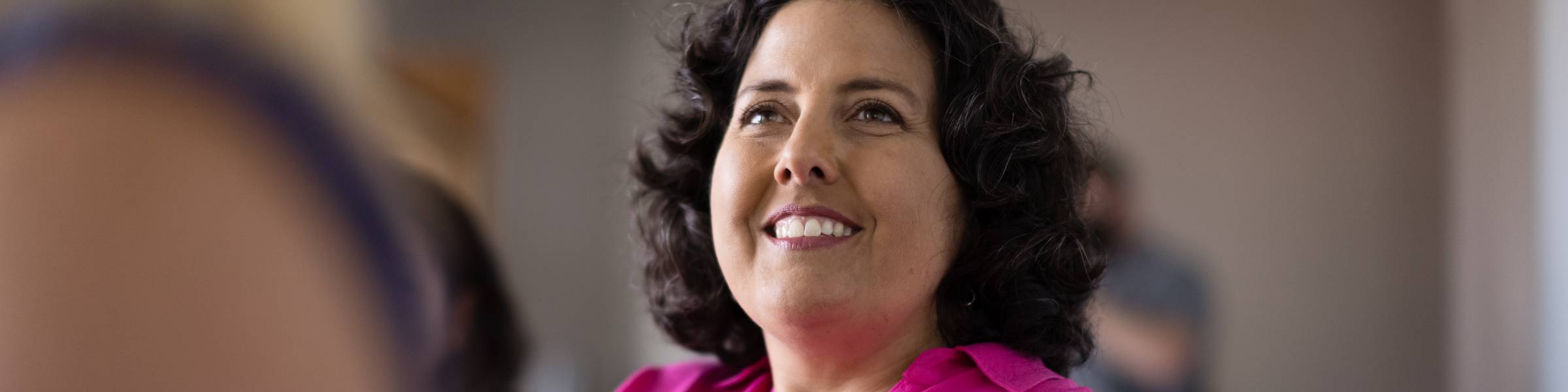 A prospective student listens to an admission counselor during an information session.