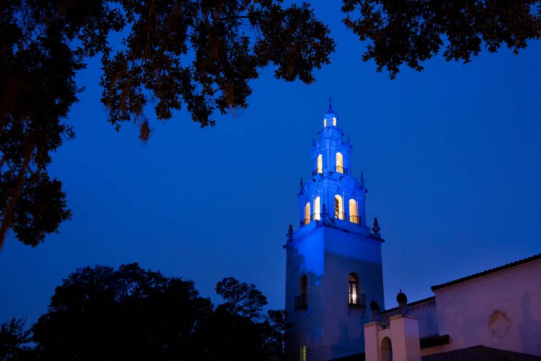 A photo of the Knowles Memorial Chapel light up at night.