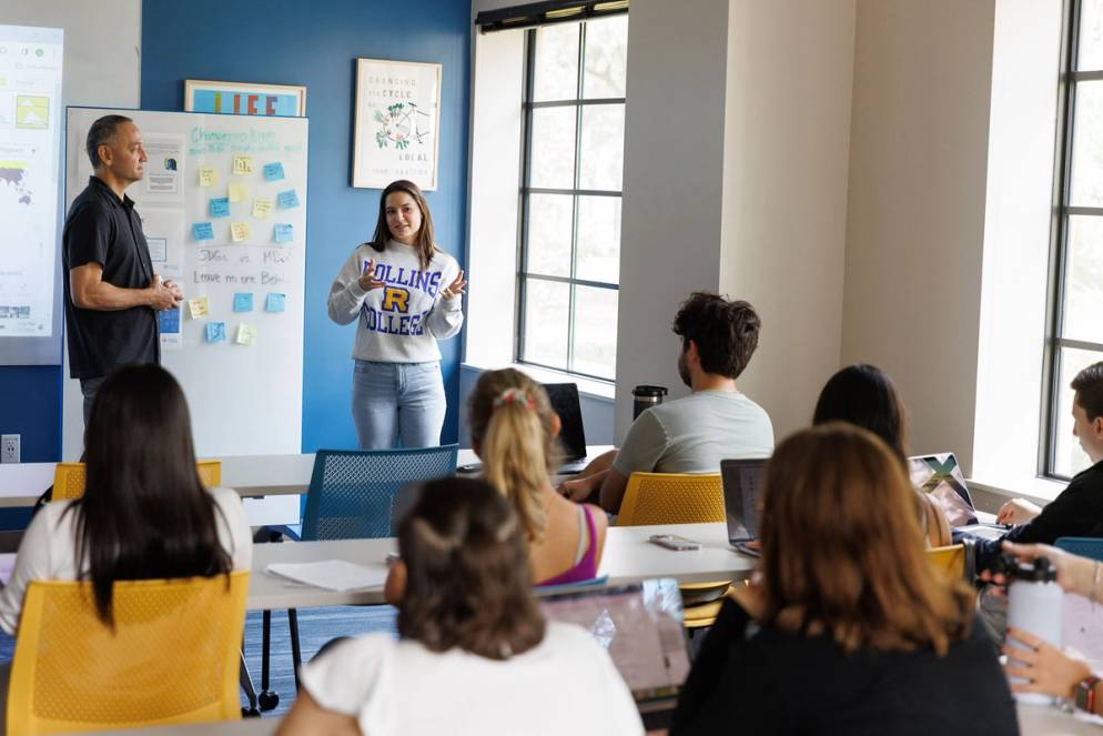 Political science student and professor lead a class discussion.