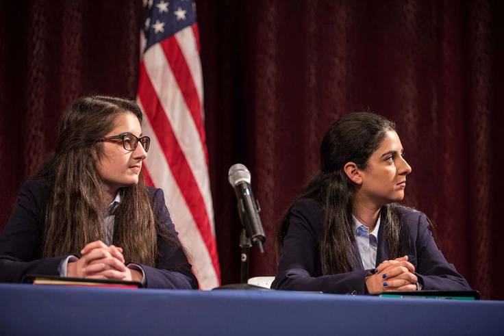 Rollins Great Debate team Whitney Elliott ’21 and Sunny Toreihi ’20 listen carefully to their competitors’ arguments.