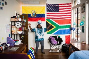 International student plays with a soccer ball in her dorm room.