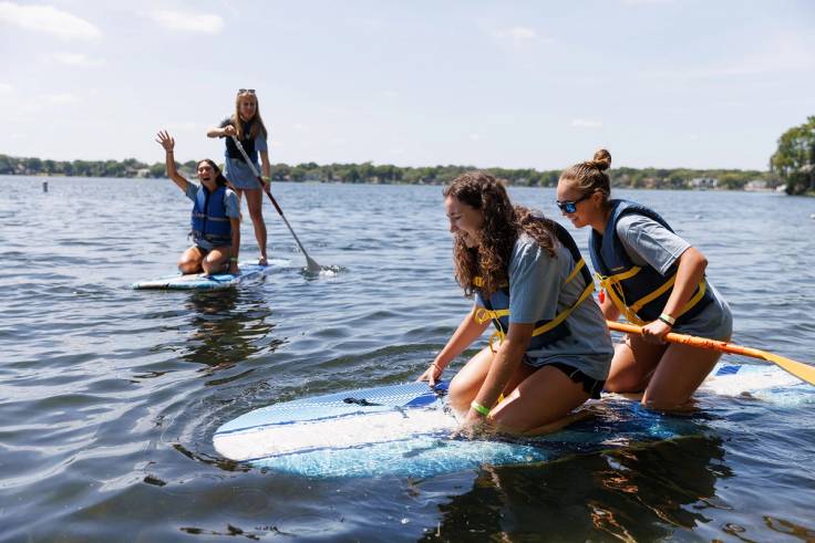 Students paddleboarding on Lake Virginia