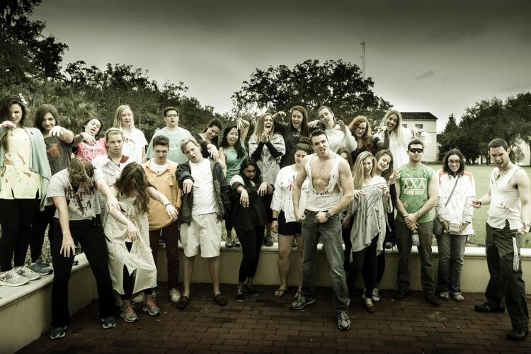 A group of students standing together dressed like zombies.