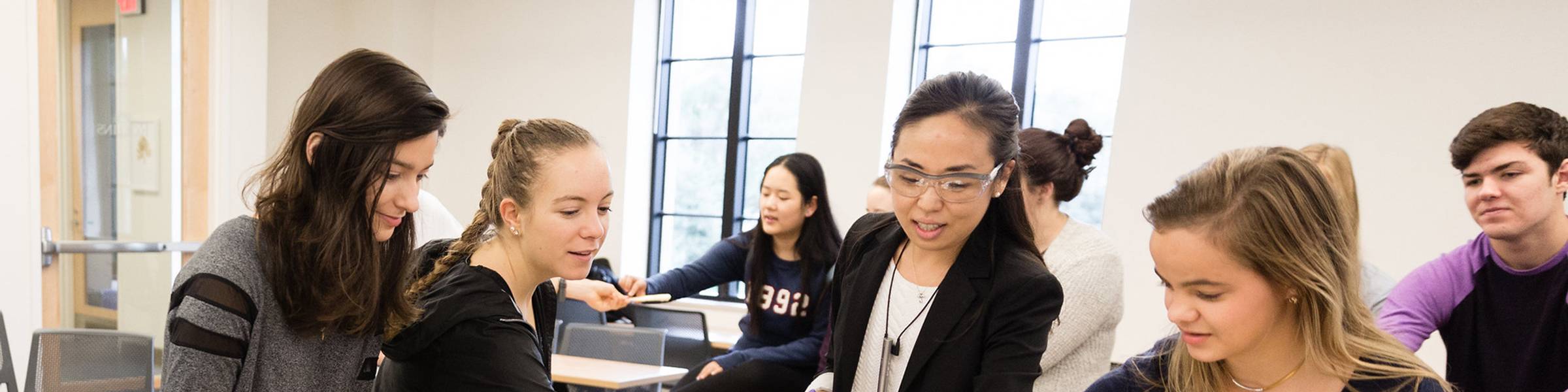Students and a professor work on a chemistry project.