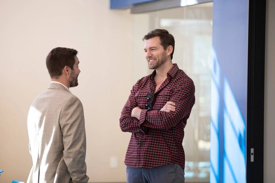 A alumni mentor chats with his student mentee.