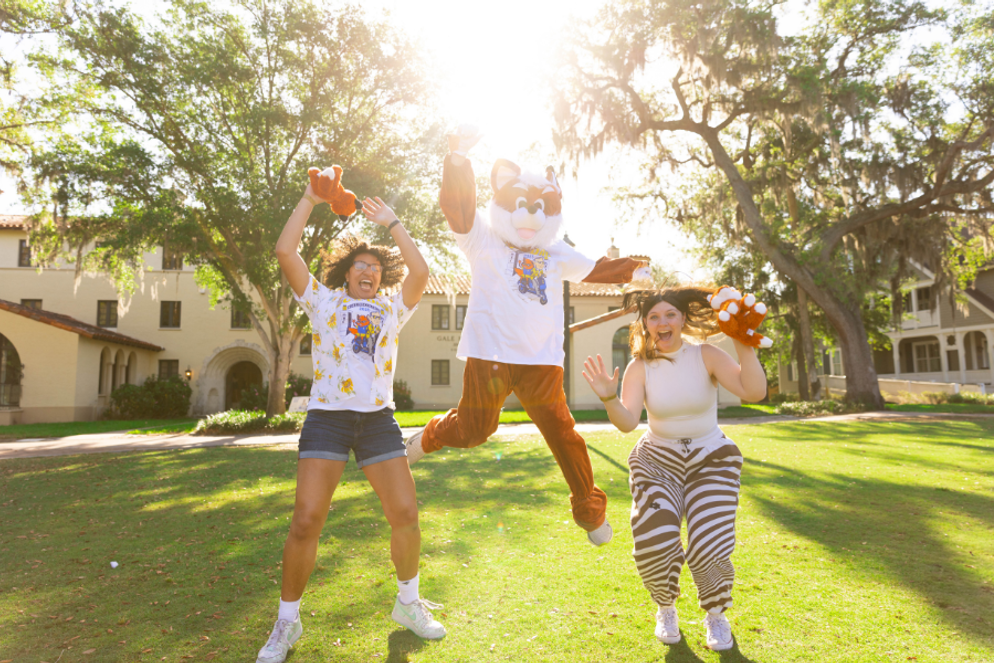 Students jumping with the fox mascot