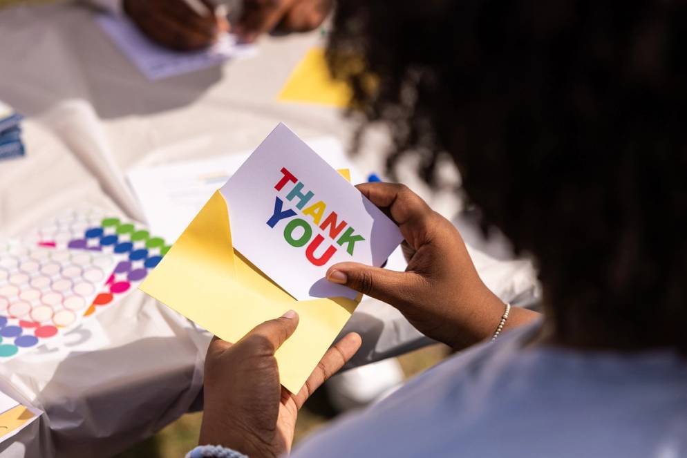 A student mailing a thank-you note on Acts of Kindness Day at Rollins