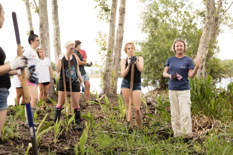 Rollins student and a professor are conducting fieldwork with shovels 