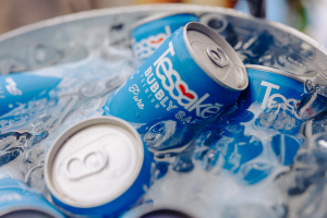 Chilled cans of Tessakē in an ice bucket.