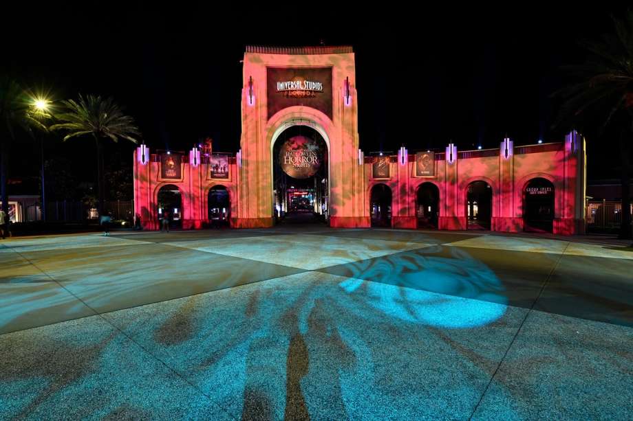 The main gate at Universal Studios Orlando lit up for Halloween Horror Nights.