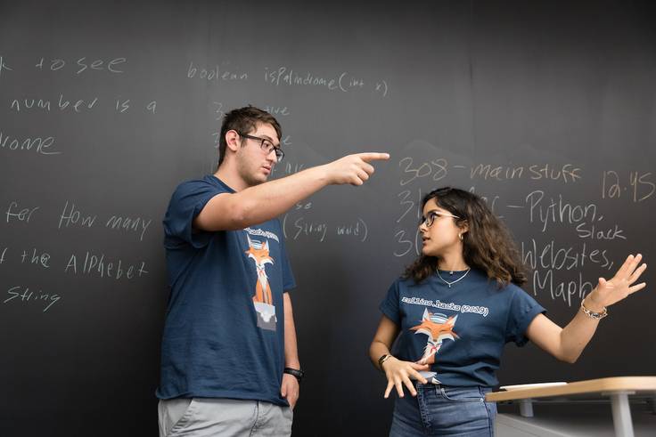 Two Rollins College students present during a hack-a-thon event.