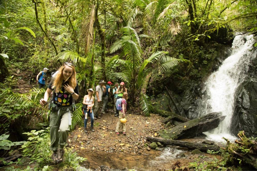 A student walks across a log in Costa Rica.